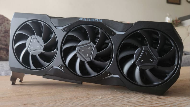 Angled shot of the AMD Radeon RX 7900 XTX on a desk surface.