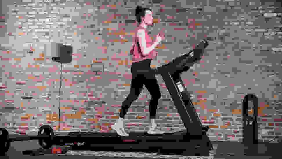 A woman uses a treadmill for a home gym.