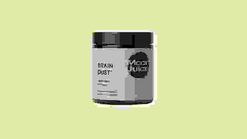 A brown and black container of Moon Juice's Brain Dust adaptogenic product with a lime/yellow background.