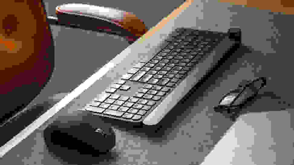 A picture of a wireless keyboard and mouse on a desk mat