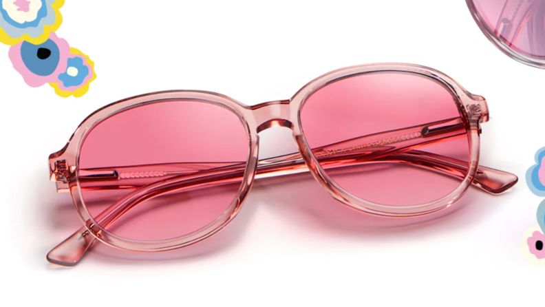A pair of bright pink, pink-lensed glasses on a white background with flowers drawn into the frame.