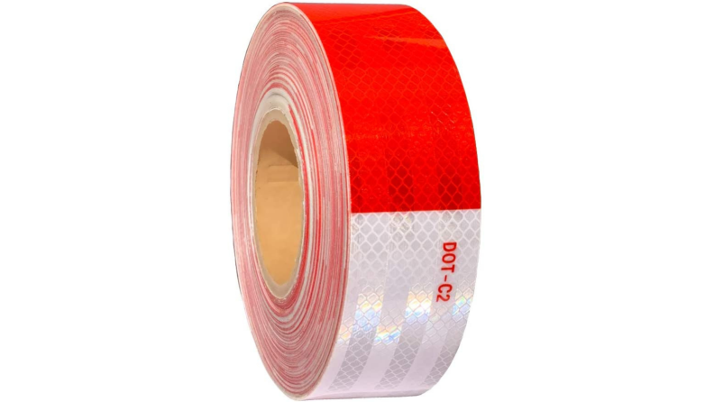 A roll of red reflective tape against a white background.