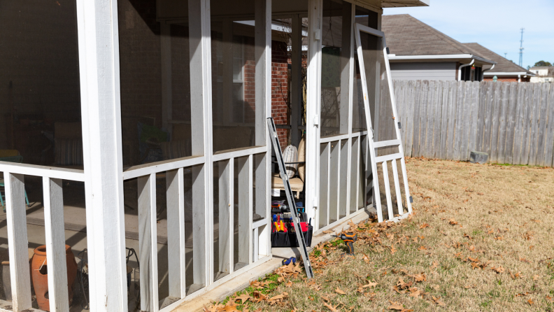 Screened in porch being built in a backyard