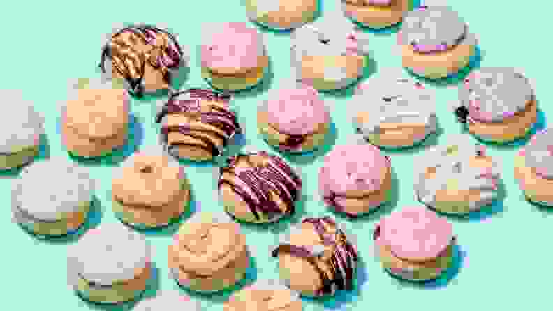 Assorted pie holes with various toppings scattered across a bright pastel blue background.