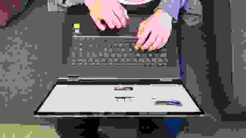 An overhead shot of a person using a laptop placed on their lap.