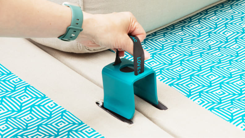 A u-shaped metal clamp fits over the sides of two base sections to connect the Sactional.