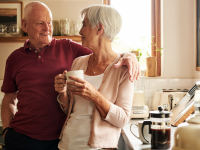A senior couple spends quality time in their kitchen together.