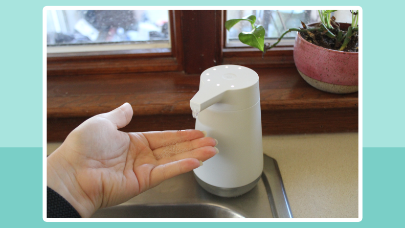 Person holding their hand under the Amazon Smart Soap Dispenser to have soap administered.