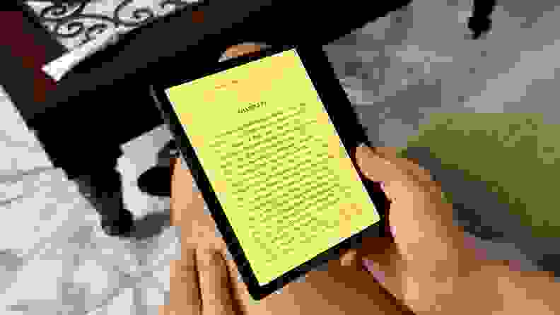 Person reading book page from the Onyx Boox Page e-reader they're holding in their hands while indoors.