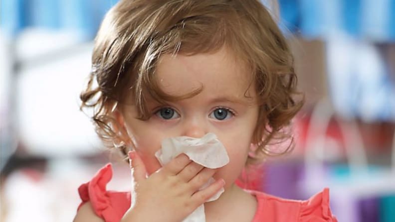 Little girl wiping her nose with a Boogie Wipe