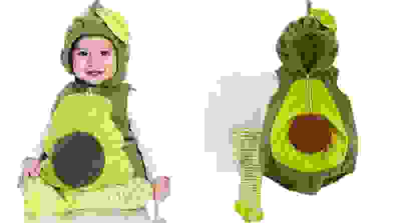 A baby dressed in an avocado costume.