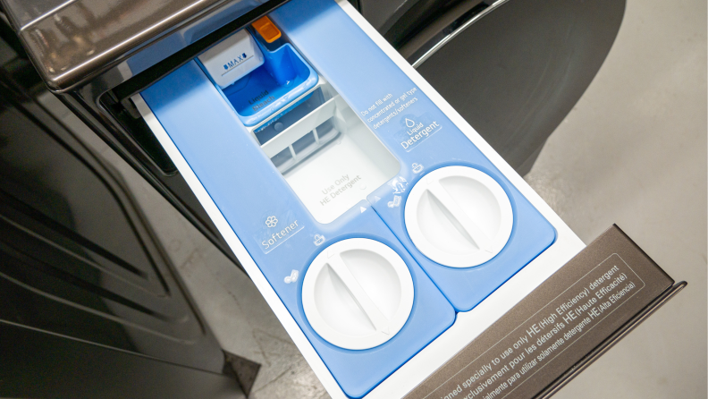 The opened automatic detergent and softener dispenser of the LG WM6700HBA washing machine.