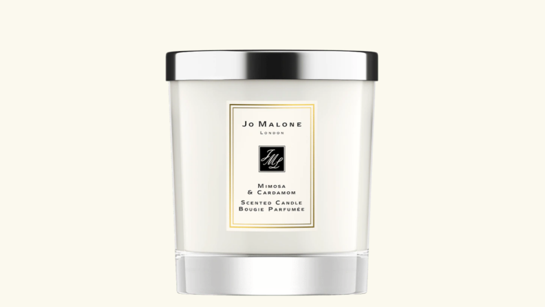 Product shot of cream colored Jo Malone Mimosa and Cardamom Home Candle.