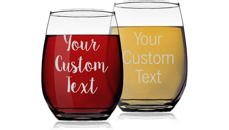 two clear wine glasses filled with red and white wine on white background.