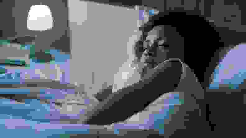 a woman asleep with a dim light on