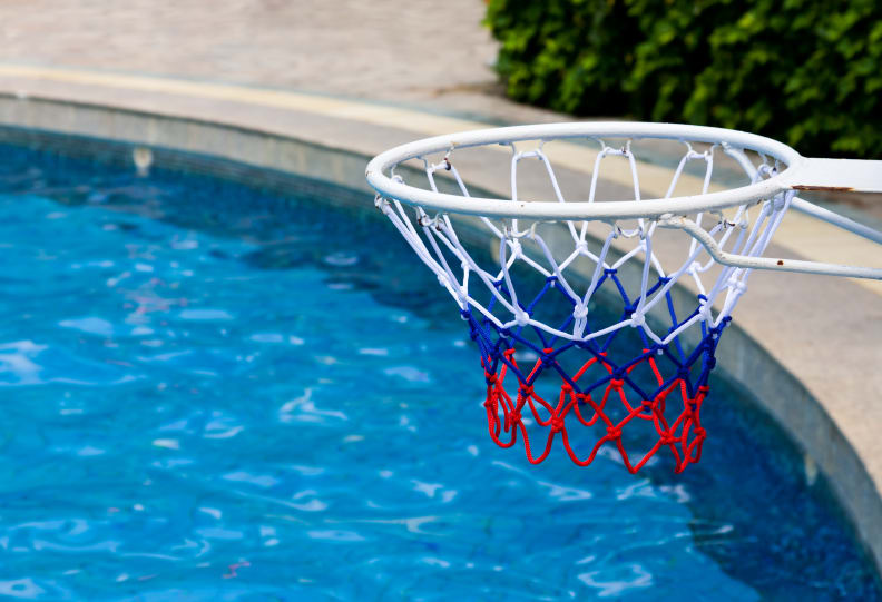 A pool basketball rim at the poolside.