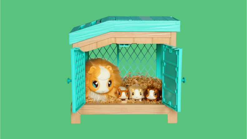 A live pets set with a large animal next to three baby animals laying in a toy barn.