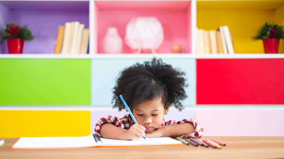 Little girls writing with a pencil