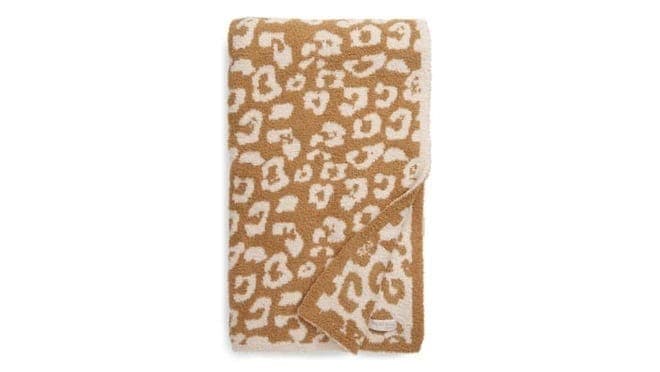 beige colored throw on white background