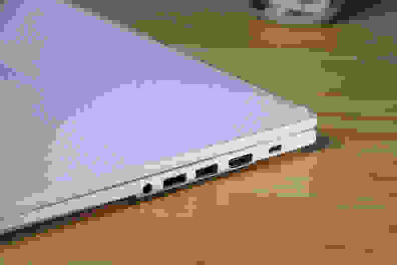 The Asus Chromebook Plus CX34 laptop on a desk, with the view of the USB connections on the side of the laptop.