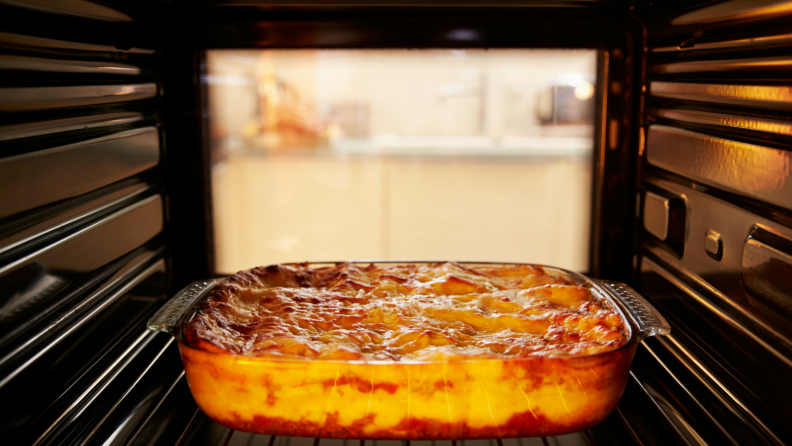 A casserole bakes in an oven.