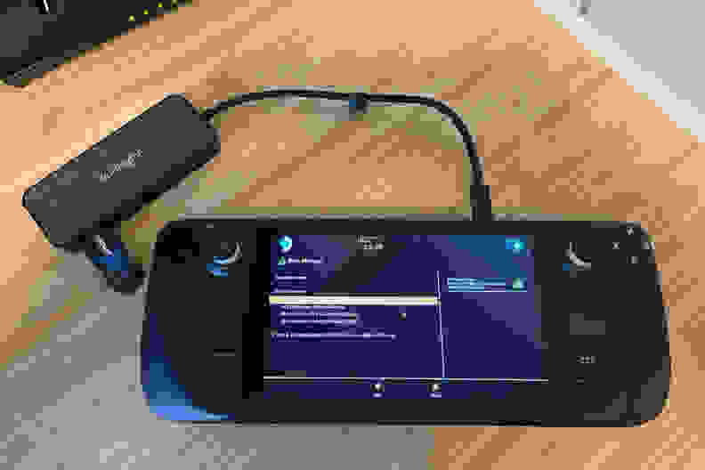 A black handheld gaming console showing part of the Windows 11 OS installation process