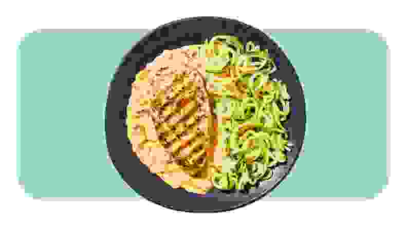 A plate served with Sun-Dried Tomato Chicken with Zucchini Noodles from the Factor meal kit.