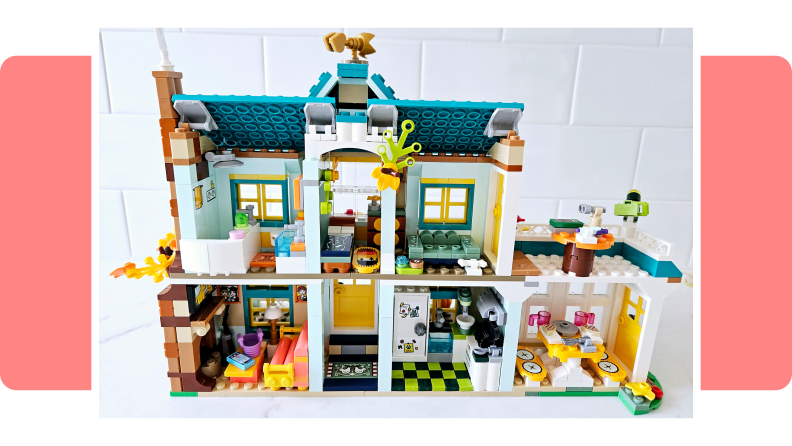 The Lego Friends Autumn's House set on a pink background.