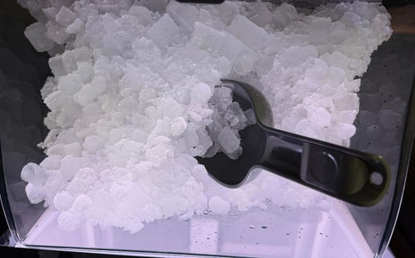 Close up photo of ice with scooper.