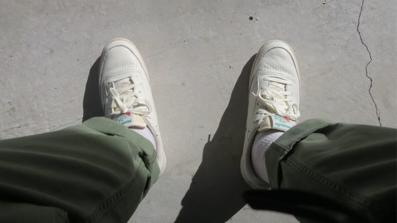 Pair of Reebok Club C 85 Vintage shoes on man's feet looking down.