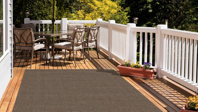 A taupe-colored rug on a deck