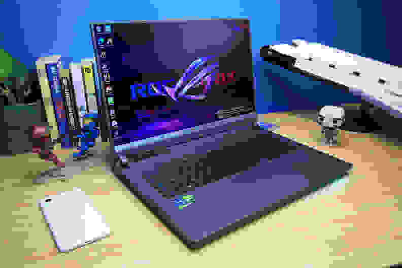 An 18-inch ASUS ROG laptop on a desk between a phone and lego space shuttle