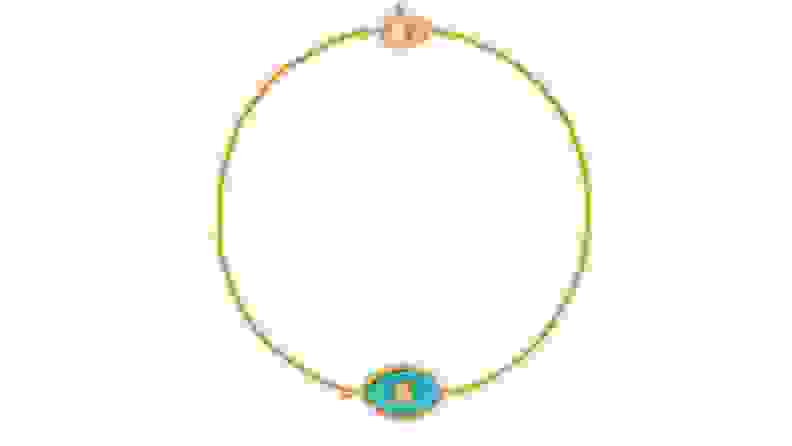Gold bracelet with aqua-colored eye charm