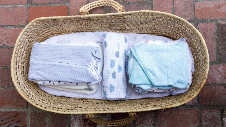 A moses basket filled with baby swaddles