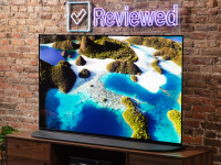 The 65-inch Sony A95K QD-OLED TV displaying colorful 4K/HDR content in a living room setting