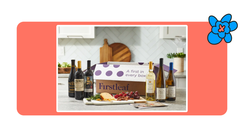 A Firstleaf Wine Subscription cardboard box behind a spread of cheese, fruits and six bottles of wine on a countertop in kitchen.