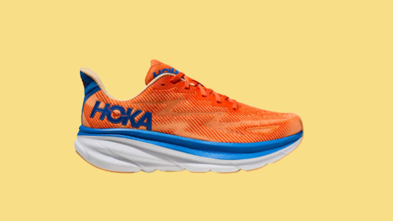 An orange and blue sneaker against a yellow background.