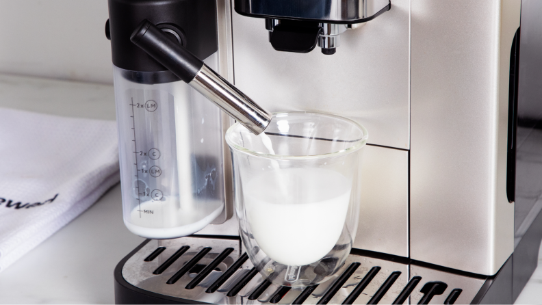 Milk being poured into a cup by the machine.