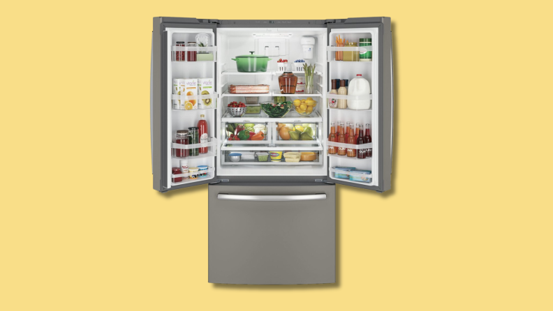 The GE GNE25JMKES french door refrigerator on a yellow background.