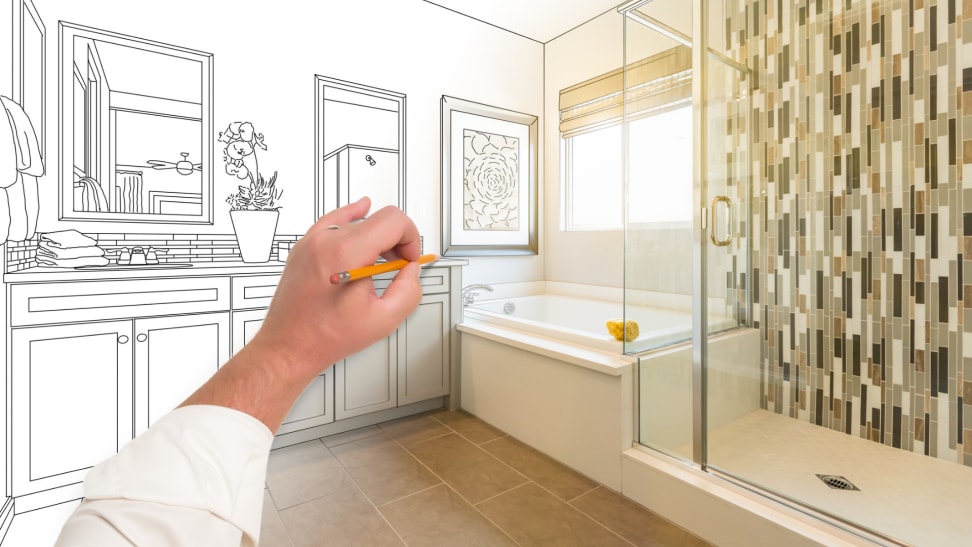 Person using pencil to draw sketch of bathroom renovation.