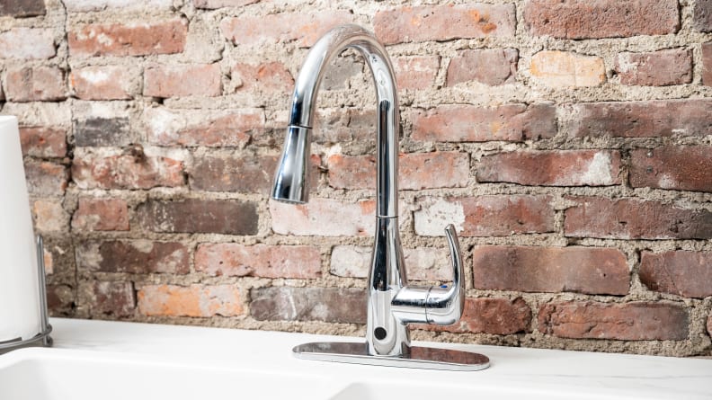 A silver faucet is attached to a white kitchen sink