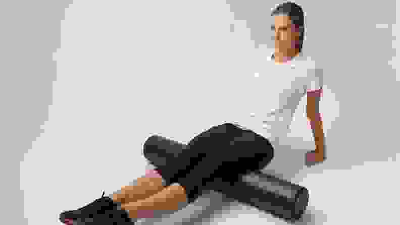 woman using a foam roller on her leg