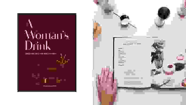 Left: A dark purple-hued cookbook titled A Woman's Drink. Right: The cookbook lays open on a white countertop surrounded by various bar tools and cocktail ingredients, with a hand pressing gently to keep the cookbook open.