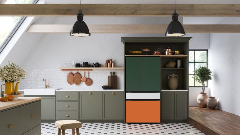 The Samsung Bespoke Fridge has been installed in a modern kitchen.  This is a French-door model with a flex drawer.  The top two doors are forest green, the flex drawer is white, and the freezer drawer is orange.