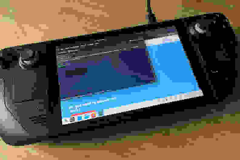 A pop-up with lots of text showing on the screen of black handheld gaming console
