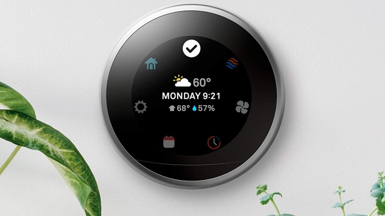 Écran LED sur thermostat intelligent circulaire monté au mur.