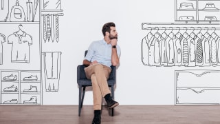 Person sitting in chair with black and white cartoon of closet drawn around them.