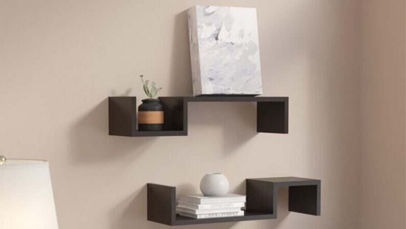 Two floating shelves with square cut outs.