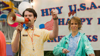 Bill Hader shouts into a megaphone in the 2009 comedy Adventureland. Standing next to him is fellow SNL alum Kristen Wiig.
