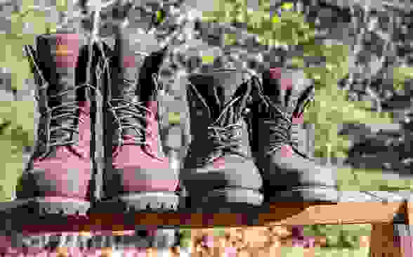 The best work boots: Two pair of work boots sitting on top of a work bench.